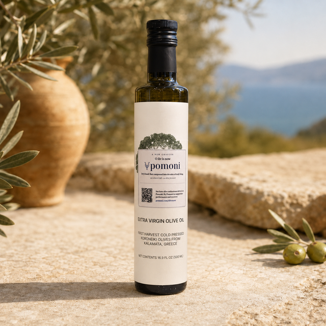 Pomoni High-Phenolic Olive Oil bottle among olive branches and a clay jar