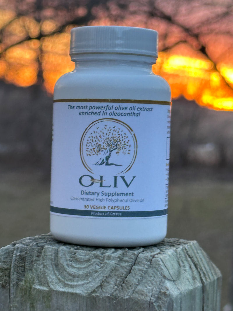Olive polyphenol supplement bottle outdoors on weathered wood at sunset
